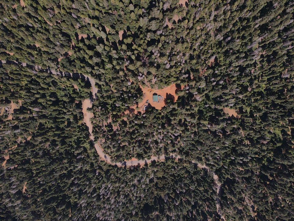 Aerial view of the forested mountain property where THE CAMPUS will be built